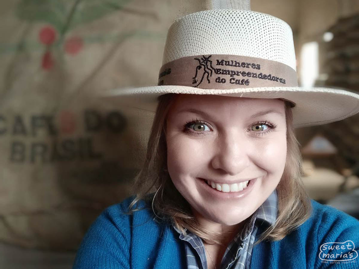 Andréia Moreira poses for a photo wearing her “Mulheres Empreendedoras do Cafe” hat, a local women’s coffee association that includes all parts of the chain.