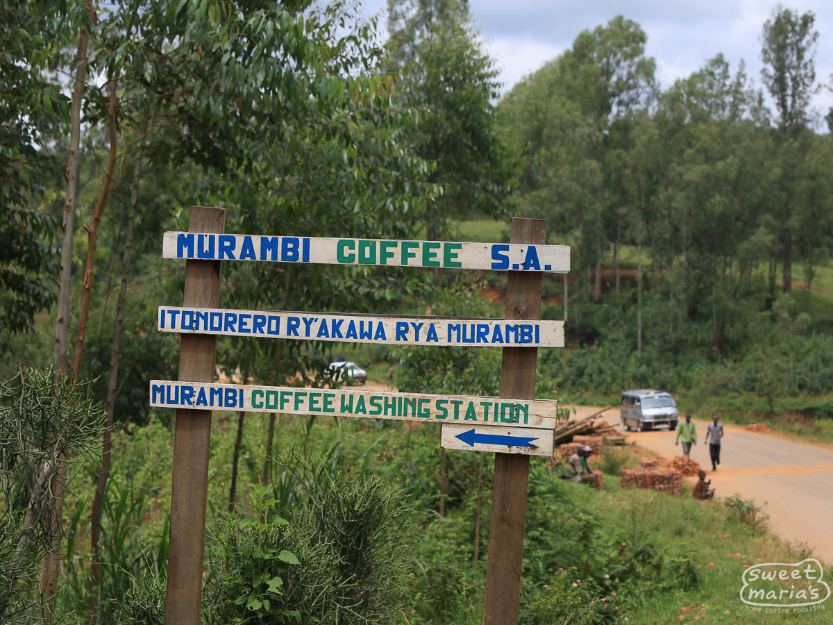 The hand-painted sign on the nearby road points the way to the Murambi coffee washing station in Muramvya, Burundi.