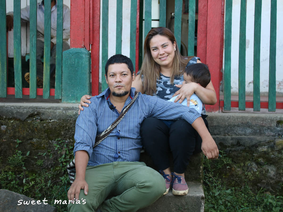 Edward and Jerly Sandoval on the front steps of their home in Santa Isabel, Tolima.