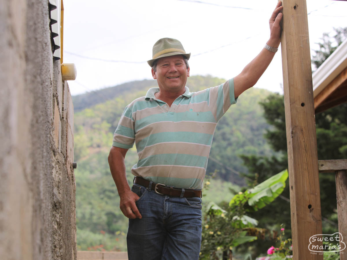 Hector Bonilla of the Don Mayo micromill poses for a photo at the top of the stairway that leads to the drying patios. Don Mayo mill, Tarrazu, Costa Rica.
