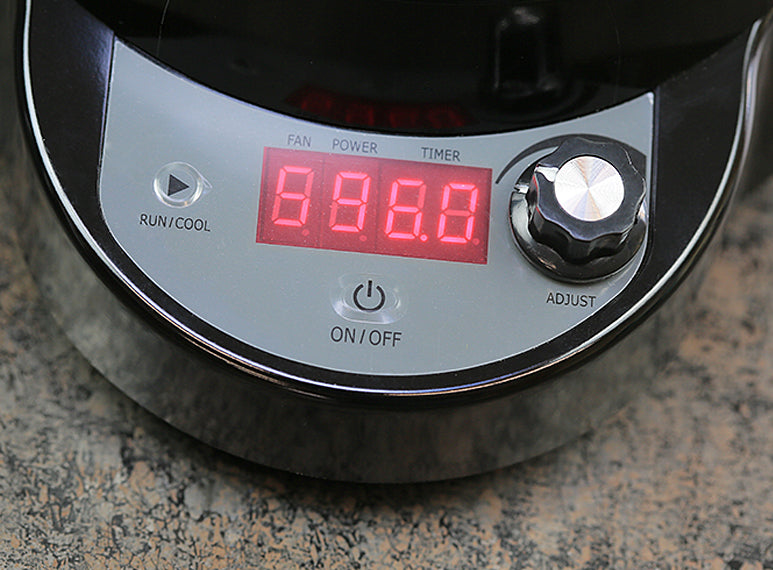 The SR800 control panel on the base of the roaster. A run/cool cycle button on the left and an on/off button in the center. A knob on the right allows users to control the fan speed