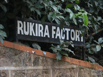 Hand-painted sign that reads, "Rukira Factory", at Rukira green coffee washing station in Othaya, Nyeri, Kenya.