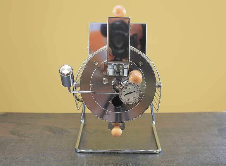 The Quest M6 electric coffee roaster has a faceplate that includes a weighted drop door