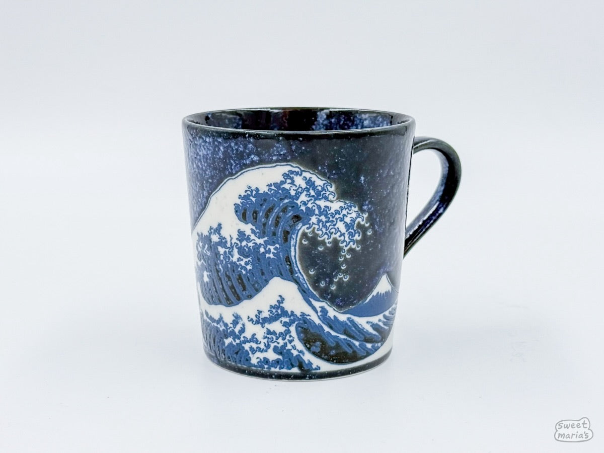 The Namako Blue Great Wave Mug features the eponymous Japanese woodblock print, "The Great Wave Off Kanagawa" by Hokusai.